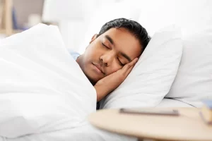 depositphotos_376948706-stock-photo-indian-man-sleeping-in-bed