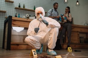forensic-investigator-examining-evidence-with-magn-2021-09-01-13-05-36-utc-min-scaled