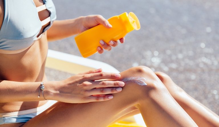 close-up-view-female-hands-applying-sunscreen-her-leg-beach-sunbathing-768x445